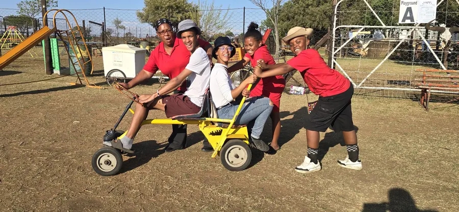 Children racing pedal karts on a track